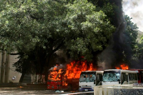 Buses are seen on fire in Bangladesh after clashes between students and government supporters in Dhaka on Sunday