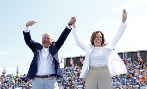 US Vice President and 2024 Democratic presidential candidate Kamala Harris and her running mate Minnesota Governor Tim Walz greet supporters as they arrive to a campaign rally in Eau Claire, Wisconsin, August 7, 2024