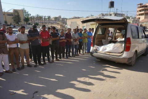 Palestinians attend the funeral of members of the Najjar family in Khan Yunis on August 12