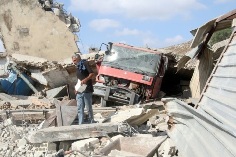 A man inspects damage after an Israeli strike in the Nabatiyeh area of south Lebanon which the country's health ministry said killed 10 people including a Syrian woman and her two children