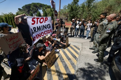 Israeli security force members stand guard during an anti-war sit-in by Israeli left-wing activists, outside the British Consulate General in Jerusalem, with Britain's Foreign Secretary David Lammy expected to arrive for talks