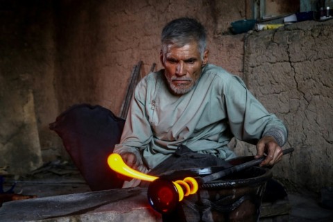 Before the Taliban takeover there was still enough demand for glassware for three days of work a week -- a distant prospect for Saifi's son who shares shifts with his father on the rare occasion they light the furnaces