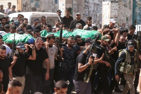 Mourners carry the bodies of two Palestinian Hamas militants killed in an Israeli air strike on Jenin in the occupied West Bank