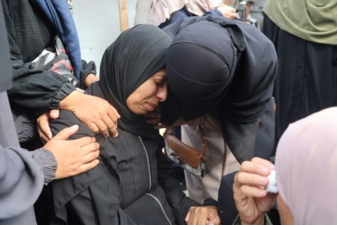 Palestinians mourn relatives killed in an Israeli strike in central Gaza at the weekend