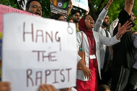 Medical professionals and students shout slogans during a protest in New Delhi