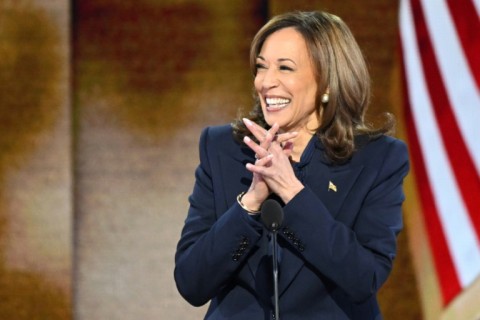 US Vice President and Democratic presidential candidate Kamala Harris (2L) stands onstage with Second Gentleman Douglas Emhoff, Minnesota Governor and Democratic vice presidential candidate Tim Walz and Gwen Walz on the fourth and last day of the Democratic National Convention 