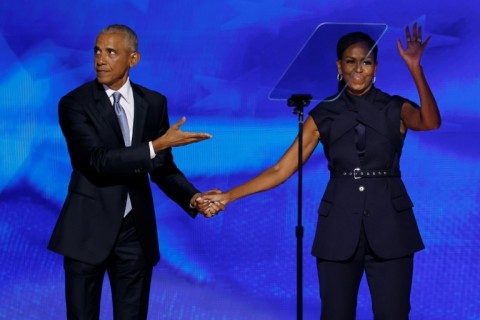 Former US President Barack Obama welcomes former first lady Michelle Obama onstage at the Democratic National Convention at the United Center on August 20, 2024 in Chicago, Illinois