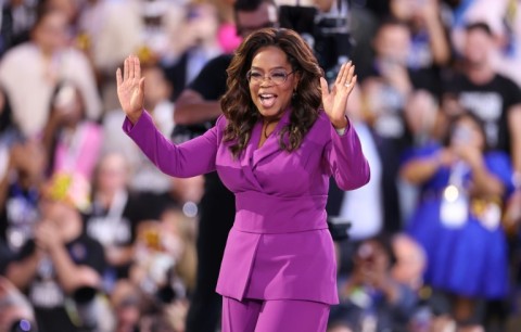 US producer/actress Oprah Winfrey waves to the crowd at the Democratic National Convention in Chicago