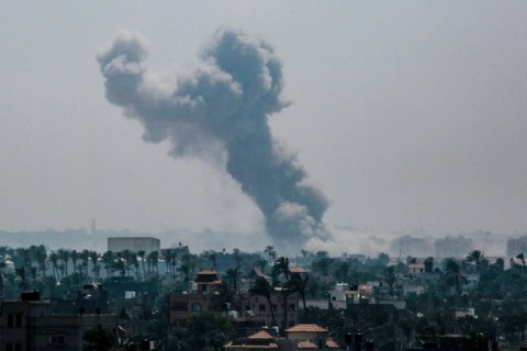 This picture taken from Deir al-Balah in the central Gaza Strip shows smoke billowing over Khan Yunis in the south following Israeli bombardment 