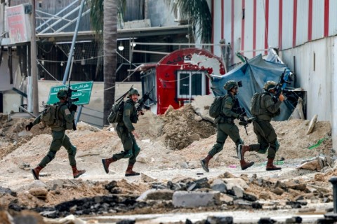 Israeli soldiers take position during an army operation in Tulkarem in the north of the occupied West Bank on August 29, 2024