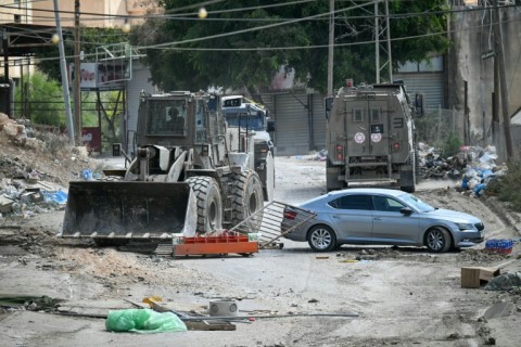 An Israeli bulldozer blocks a road during a raid in the Al-Faraa camp for Palestinian refugees near Tubas