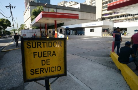 An out of service sign is pictured at a petrol station during a blackout in Caracas on August 30, 2024