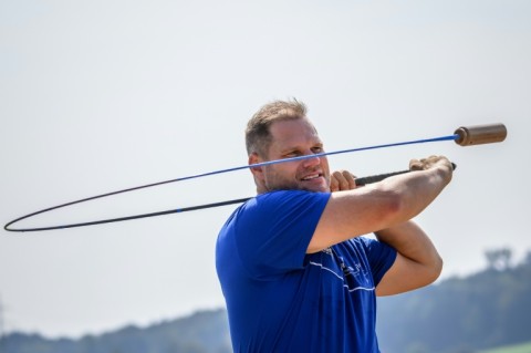 Stefan Studer, the sport's top player, looks at his shot after hitting the hornuss