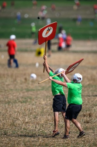 Using wooden shovels, the defending team tries to stop the hornuss landing untouched in the field