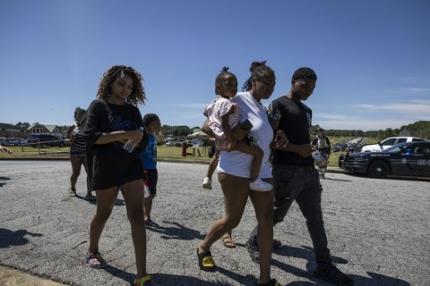 Parents and students leave the scene after being reunited after the shooting