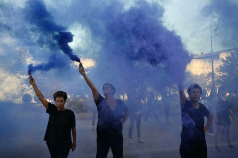 Protesters wave smoke bombs during the trial in the southern French city of Avignon of a man accused of drugging his wife Gisele Pelicot for nearly ten years and inviting strangers to rape her