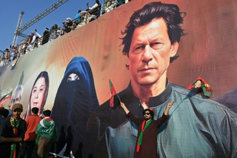 Supporters of the Pakistan Tehreek-e-Insaf (PTI) party of former prime minister Imran Khan (depicted in mural), take part in a rally on the outskirts of Islamabad on September 8, 2024