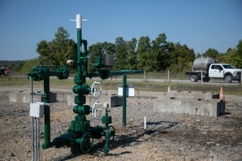 A truck from another well site drives by a Diversified Energy natural gas well site in Franklin Township, Washington County, Pennsylvania