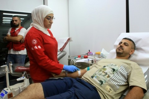 A man donates blood in the southern Lebanese city of Sidon on September 17, 2024, a day after the deadly explosions