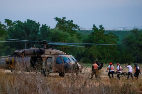 Rescue teams evacuate wounded people near Israel's southern city of Sderot on October 7, 2023