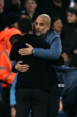 Manchester City manager Pep Guardiola (right) hugs Arsenal boss Mikel Arteta 