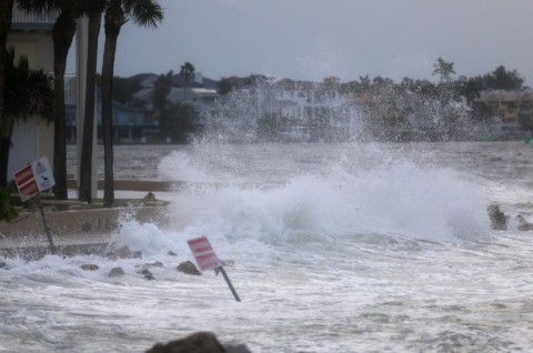 David Hester (L) and Bo Hester inspect the damage wrought by Hurricane Helene in Horseshoe Beach, Florida