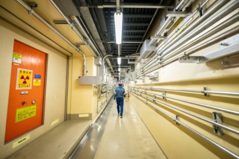 Masaki Daito, deputy superintendent of the Kashiwazaki-Kariwa nuclear power station, walks through a corridor inside the unit 7 reactor building