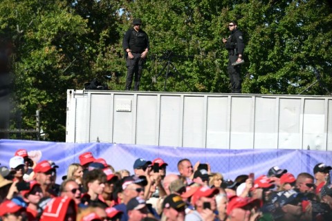 Snipers stand on a roof ahead of Trump's rally at the site where he was nearly killed in July