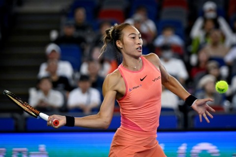 China's Zheng Qinwen hits a return to Italy's Jasmine Paolini during their women’s singles quater-final match at the Wuhan Open tennis tournament