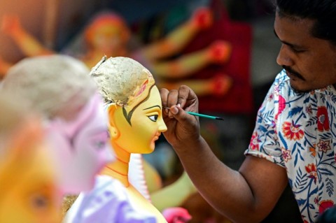 The clay idols, painstakingly crafted and painted in dazzling colours over weeks, are eventually immersed into the sacred river 