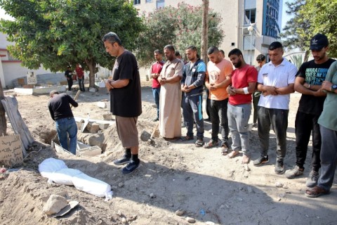 Relatives pray over the shrouded body of Sama al-Debs, 10, who was killed during an Israeli army operation in the Jabalia refugee camp in the central Gaza Strip