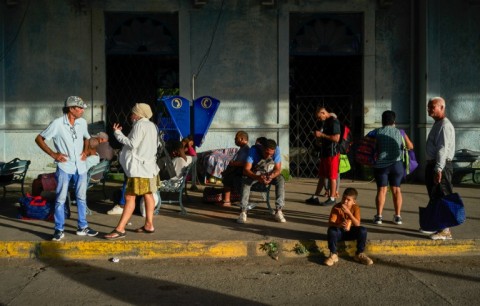 People wait for transportation at a bus station in Matanzas, Cuba, on October 18, 2024, during a nationwide blackout 