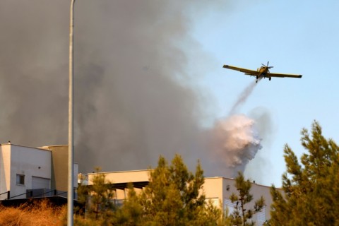 Israeli firefighters use aircraft to battle the flames on a hill after rockets were fired from southern Lebanon, on the outskirts of Rosh Pinna in the Upper Galilee 