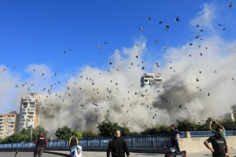 Smoke and pigeons rise after an Israeli strike on Beirut's southern suburbs