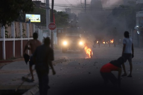 Some protesters also threw stones at riot police, who responded with tear gas