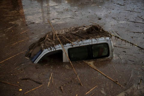 A sunken car covered with mud seen in a flooded street in Alora, near Malaga