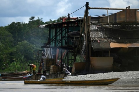 Dredgers used to extract gold are seen in the Quito river, a tributary of the Atrato river