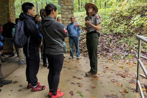 A ranger at Mammoth Cave National Park speaks with visitors before entering the cavern, including discussing white-nose syndrome which affects bats