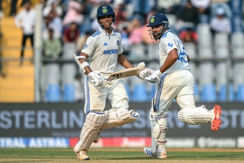 India's captain Rohit Sharma and his teammate Yashasvi Jaiswal (L) during the first day of the third Test against New Zealand