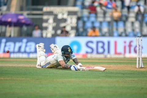 Virat Kohli is being run out by New Zealand's Matt Henry as India struggled on a gripping first day of the third Test at the Wankhede Stadium in Mumbai