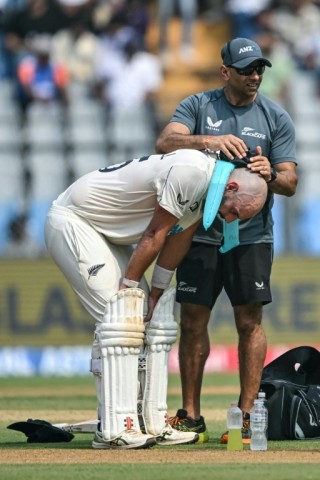 Cool aid: New Zealand's Daryl Mitchell takes an ice break during his top score of 82 in Mumbai