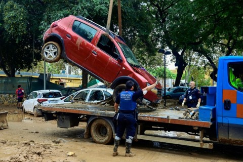 Police remove flood-damaged cars in Alfafar, in the region of Valencia