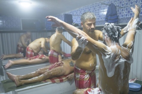 Bathing attendants help with the washing ritual