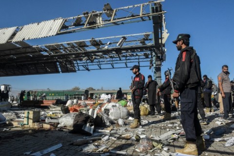 Firefighters, rescuers and passengers were working through abandoned luggage on the platform, guarded by heavily armed members of the security forces