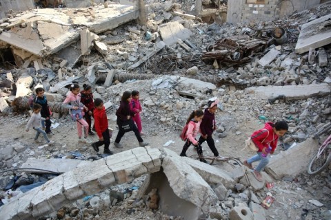 Palestinian girls walk among rubble of a building destroyed by previous Israeli bombardment in Gaza City -- the United States said 'very, very low' levels of aid to Gaza must increase