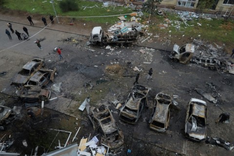 Ukrainian residents inspect burnt-out cars following a drone attack in Odesa on November 9, 2024, amid the Russian invasion 