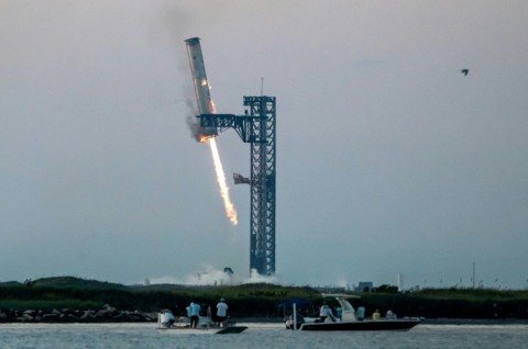 Starship's Super Heavy Booster is grappled at the launch pad in Starbase near Boca Chica, Texas in October 2024, during the Starship Flight 5 test