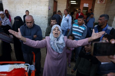 A Palestinian woman reacts as victims of an Israeli strike are transported to al-Aqsa Martyrs Hospital in Deir el-Balah, central Gaza