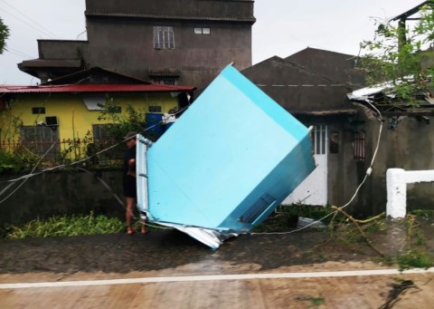 Photo courtesy of John Marshal Aquino shows a blown over structure along a street in Panganiban, Catanduanes