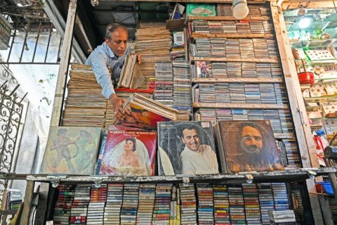 Royal Music Collection store owner Abdul Razzak arranges vinyl records at his shop in Mumbai